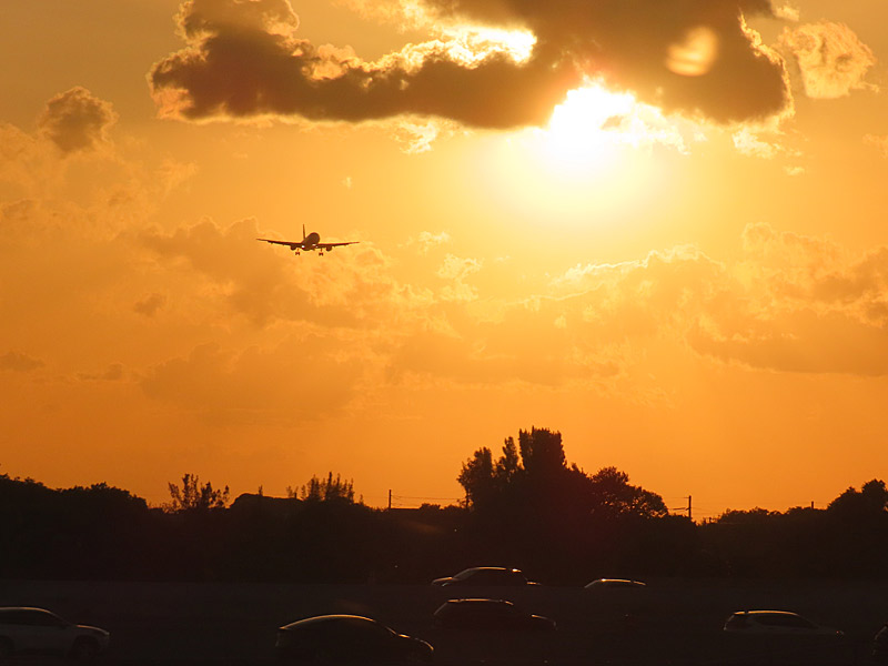 Waiting for my flight to take off from Fort Lauderdale, Florida, not long before sunset - another jet comes in from the west for a landing. - photo by Joe Alexander