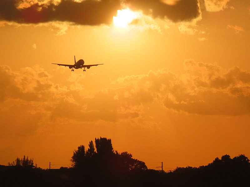 Waiting for my flight to take off from Fort Lauderdale, Florida, not long before sunset - another jet comes in from the west for a landing. - photo by Joe Alexander