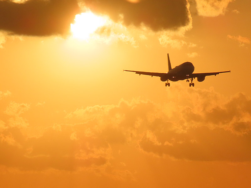 Waiting for my flight to take off from Fort Lauderdale, Florida, not long before sunset - another jet comes in from the west for a landing. - photo by Joe Alexander
