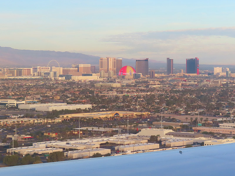 View of the Las Vegas Strip while landing. The Sphere is the round red and yellow object in the middle. - photo by Joe Alexander