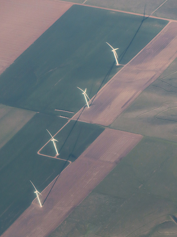 Tall wind turbines as seen from the air on a sunny morning in Colorado shortly before descending into Denver International Airport. - photo by Joe Alexander