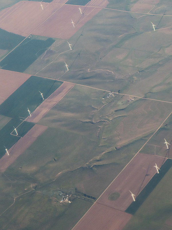 Tall wind turbines as seen from the air on a sunny morning in Colorado shortly before descending into Denver International Airport. - photo by Joe Alexander