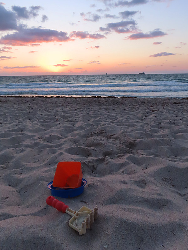 Something forgotten after yesterday's sunset sets the stage for today's sunrise. View of the sunrise over the Atlantic Ocean from Fort Lauderdale Beach, Florida. - photo by Joe Alexander