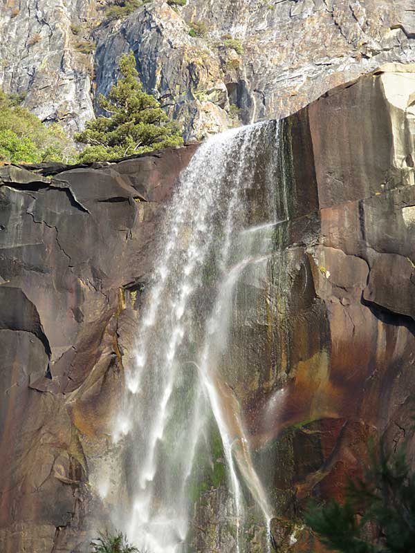 Bridal Veil Falls is brought to light by full sunlight by late afternoon. Even at the end of autumn when the water levels in Yosemite Falls are lower, it is a an impressive sight. – photo by Joe Alexander