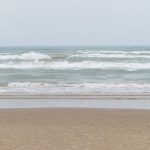 The beach was filled with families on a hazy, cloudy weekday afternoon in June. - photo by Joe Alexander