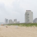 The beach was filled with families on a hazy, cloudy weekday afternoon in June. - photo by Joe Alexander
