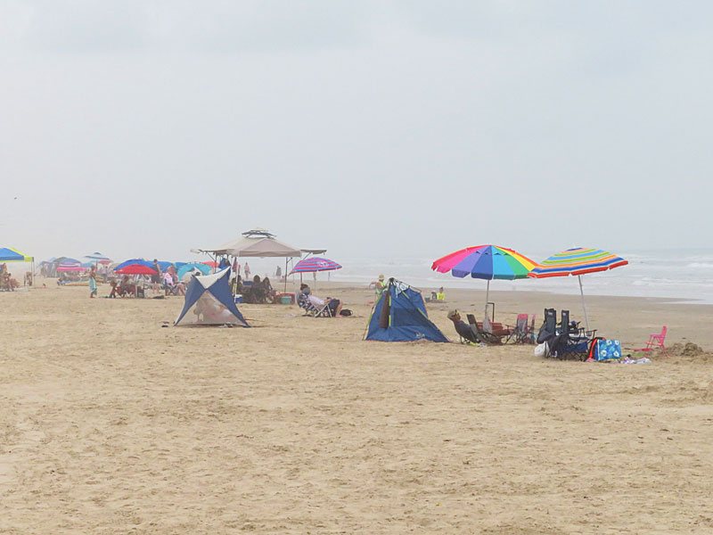 The beach was filled with families on a hazy, cloudy weekday afternoon in June. - photo by Joe Alexander