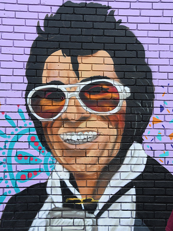 Mural in progress of San Antonio legend Hispanic Elvis at Viva Fiesta Paint Jam facing Guadalupe Street at South Flores Street.