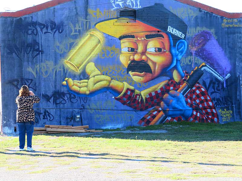 The ‘BURNER’ mural covers the northern end of this long building at The Paint Yard on Hoefgen Street near downtown San Antonio south of the Alamodome.